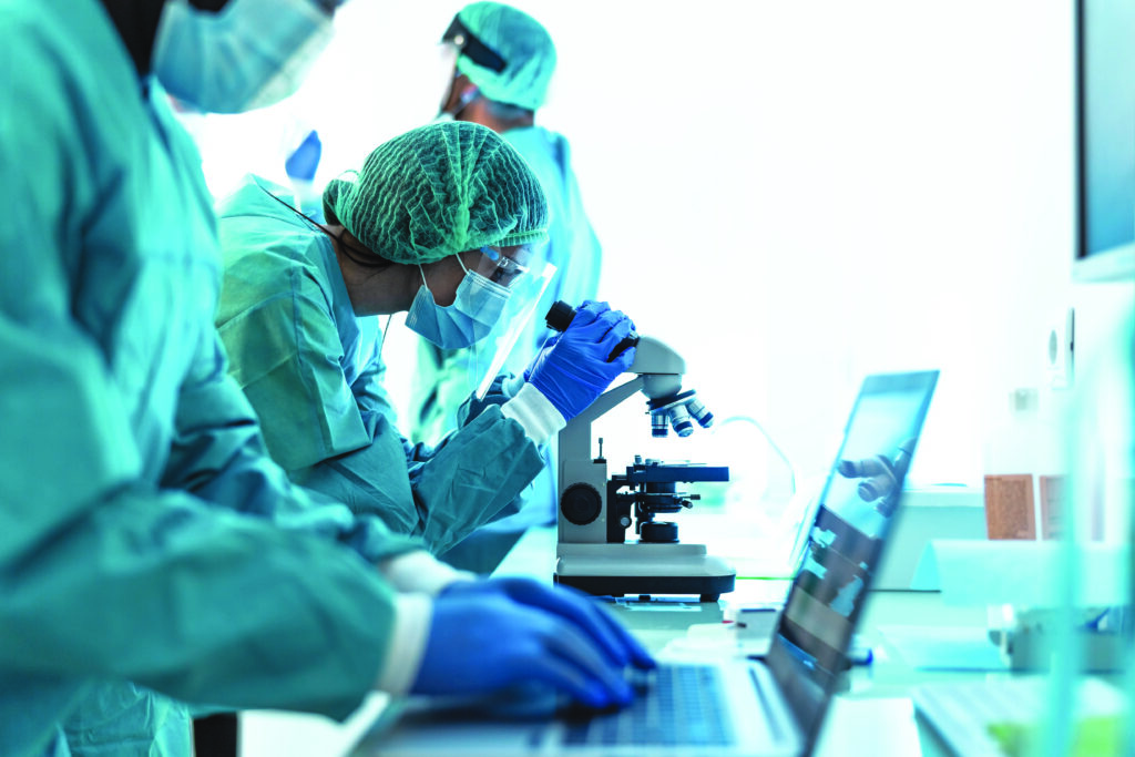 Medical workers doing analysis in laboratory during corona virus outbreak- Science and healthcare concept